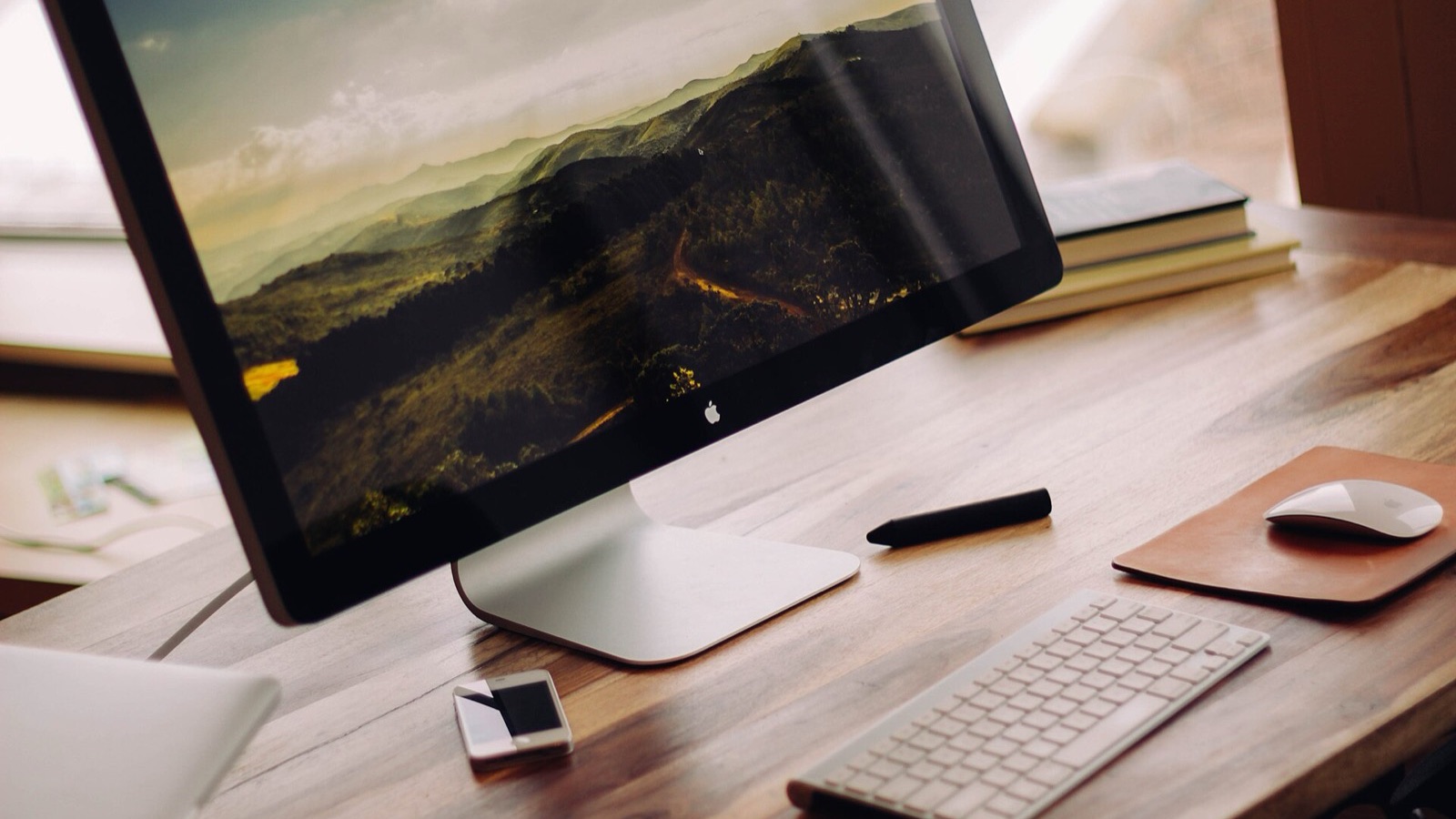 Desktop monitor and keyboard workstation setup on an office desk